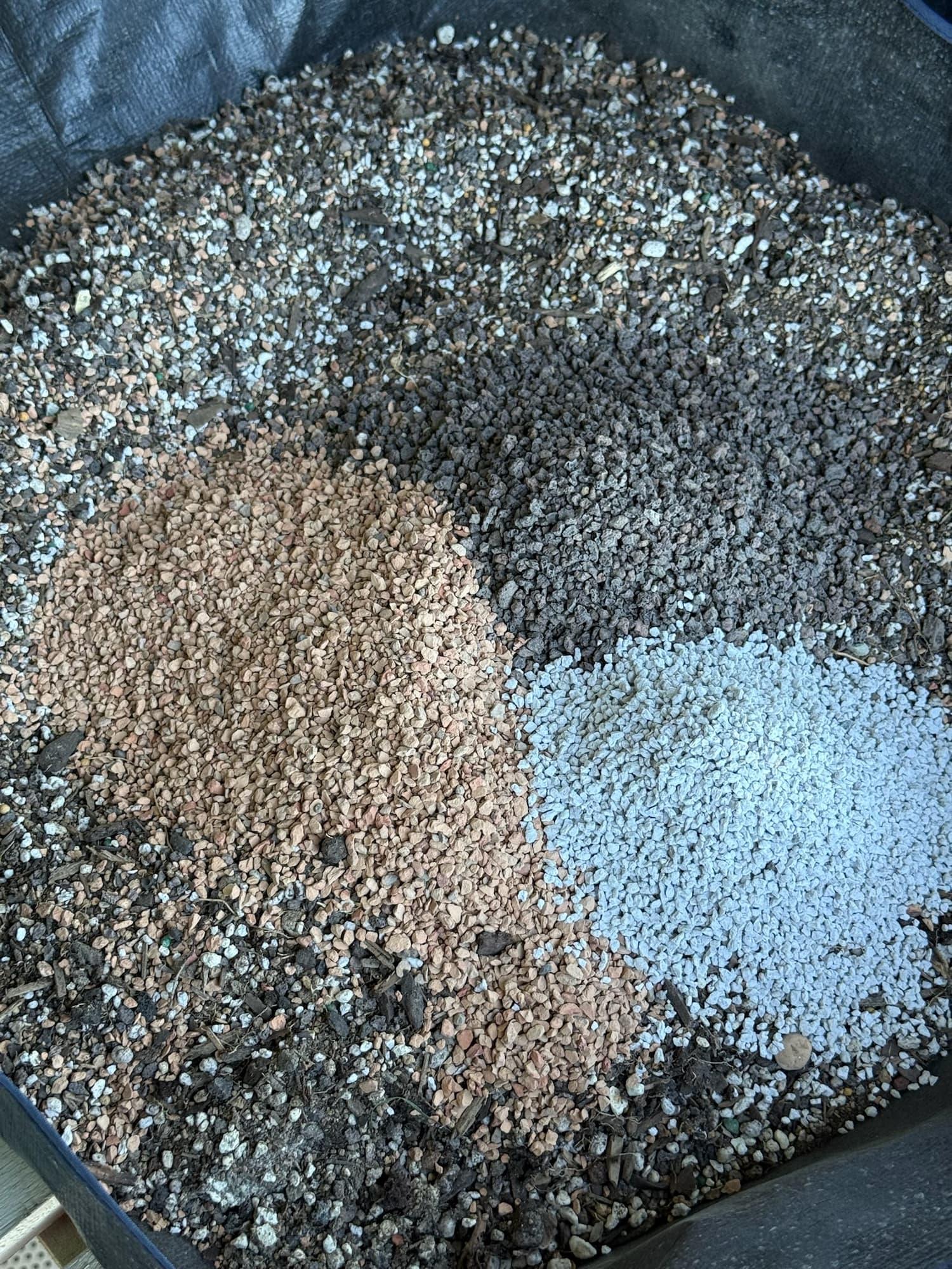 Bonsai soil components in a tub: tan akadama clay, dark lava rock and white pumice in piles beside the mixed blend